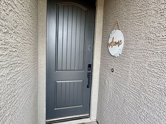 Private covered front entry with upgraded front door