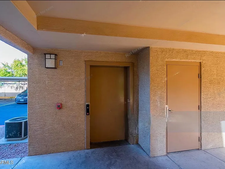 Elevator from ground level. View of carport in the background with your parking spot.