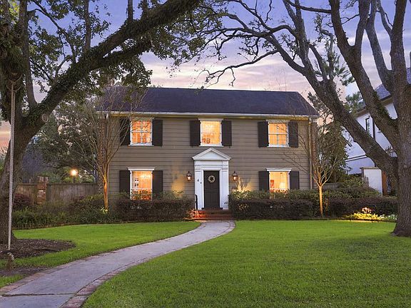 The exterior is beautifully landscaped and the front facade is gracefully framed by two mature oak trees.