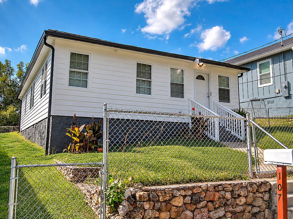 Front corner view of home with fully fenced in yard. New glass door