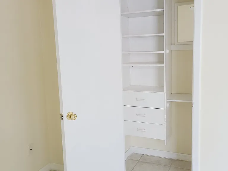 Guest bedroom closet with mirror