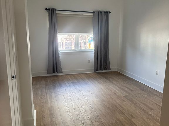 Spacious primary bedroom with a private ensuite and full bathroom, offering scenic views of Central Avenue.