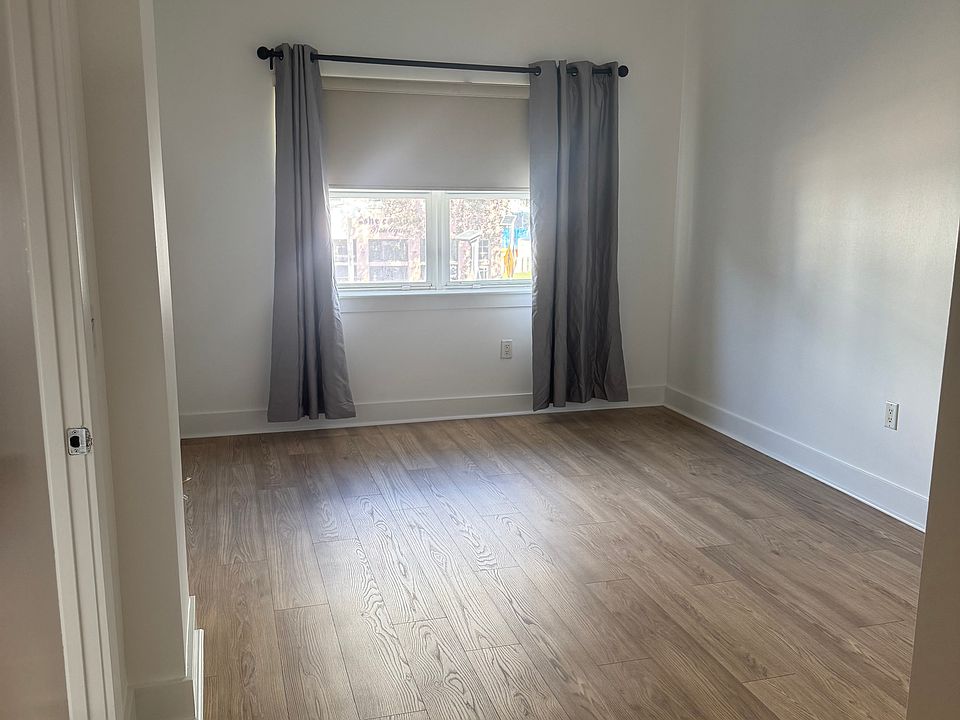 Spacious primary bedroom with a private ensuite and full bathroom, offering scenic views of Central Avenue.
