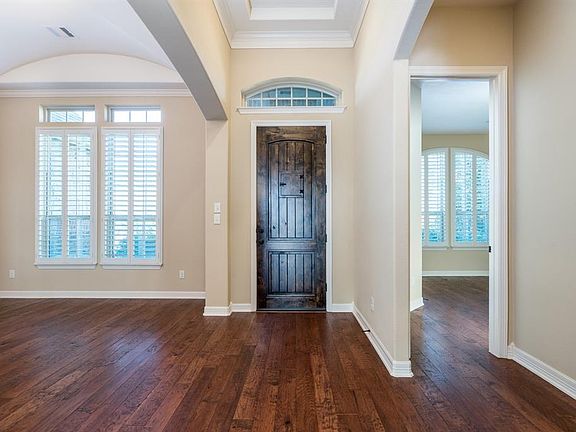 Now come inside and take a look at the most functional floor plan around. The spacious entry features a mission style front door with a unique "speak-easy" portal, hardwood flooring and a soaring double tray ceiling for architectural interest.