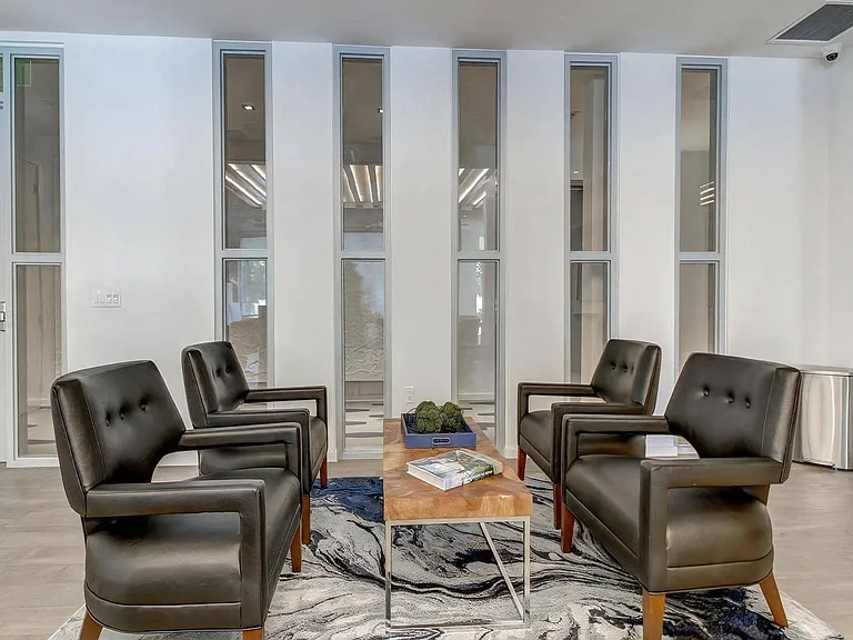 Waiting Area with Accent Rug, Leather Chairs, and Wood Table
