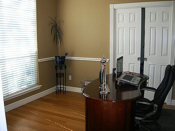 Study/office has wood floor,decorator paint, access to extra room,french doors