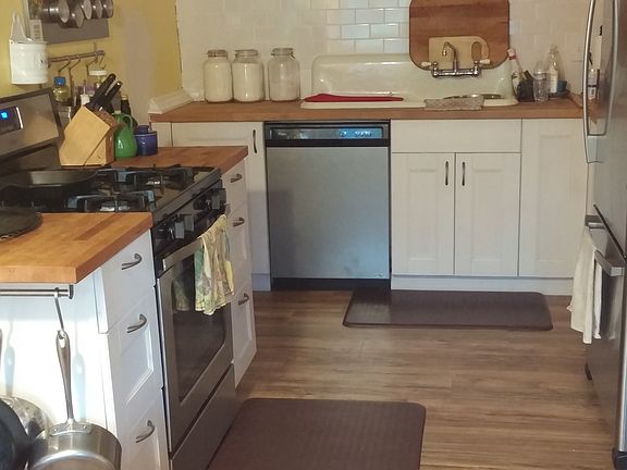 Eat in kitchen with dishwasher, fridge, and range.