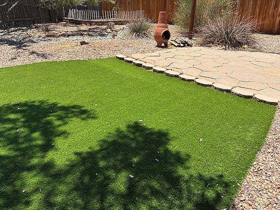 back yard, flower garden in the corner option, flagstone patio, wood burning patio chimenea
