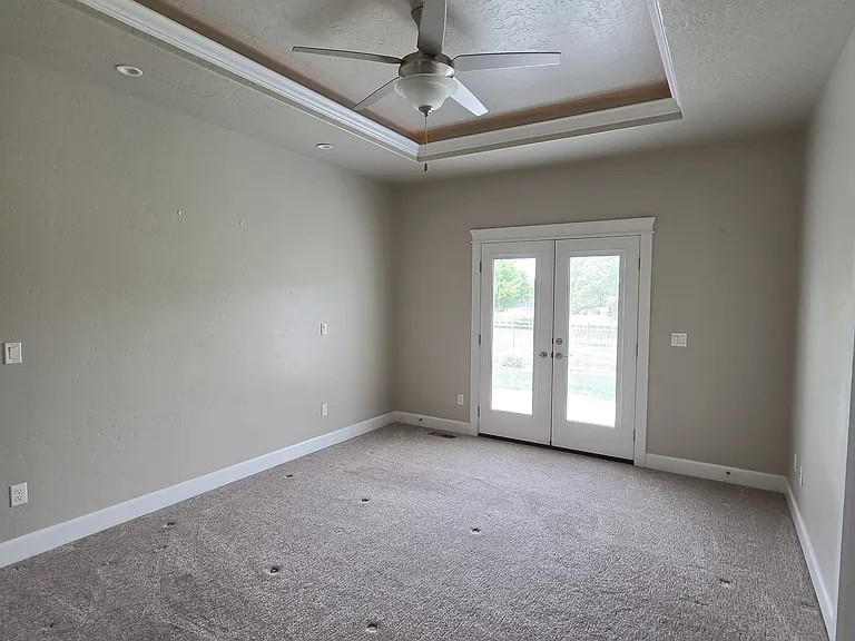 MASTER BEDROOM WITH LED COVE CEILING AND FAN. FRENCH DOORS TO BACKYARD HAVE INTERNAL ADJUSTABLE MINI BLINDS.