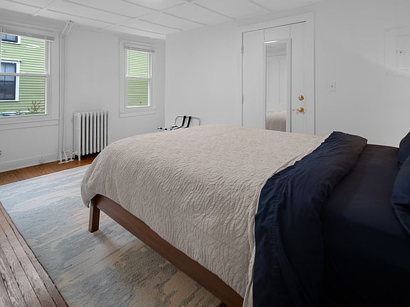 Bedroom with Queen Bed, Nightstand, Lamp, Rug, plus Navy Blackout Curtains(not photographed)