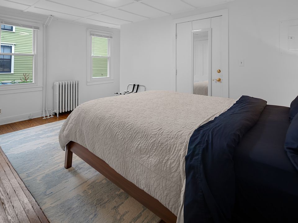 Bedroom with Queen Bed, Nightstand, Lamp, Rug, plus Navy Blackout Curtains(not photographed)