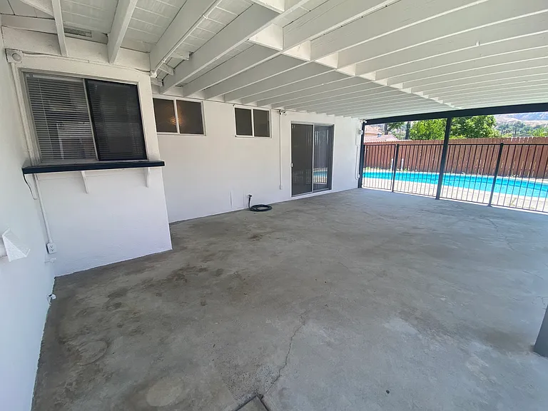 Large covered patio with pass-through window to kitchen.