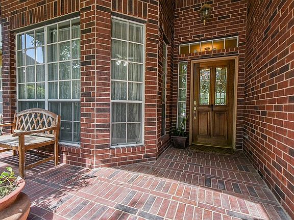 This charming covered front porch is a perfect spot for your morning coffee or sun-loving flowers!