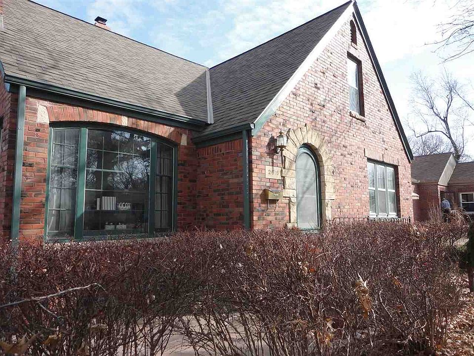 Brick tudor with rounded top front door and arches through out main floor