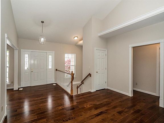 A view toward the Main Entry and guest parking beyond.  The opening to the right leads to the Southern Bedroom Wing.  The opening to the left is the Dining Room.  This photo gives you a nice view of the flooring that unites the spaces.