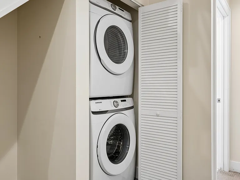 In-unit washer and dryer on the lower-level bedroom floor