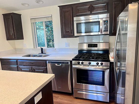 kitchen - sink, counter space, cabinets, dishwasher, stove, microwave, and fridgerator (plus island)