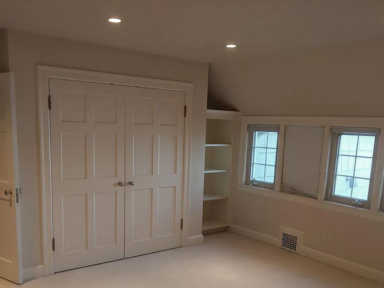 Master Bedroom has 3 built in closets, bookshelf, and recessed lighting on dimmers. Black out window shades and new carpet! Solid core doors throughout entire home = privacy and security