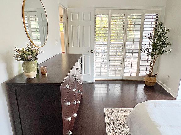 Antique chest of drawers ensures you have plenty of space for storage, plus en-suite access onto the covered balcony gives you an extra sense of privacy.