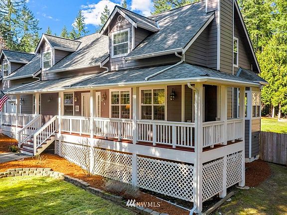 COVERED FRONT PORCH THAT WRAPS-AROUND THE EAST SIDE