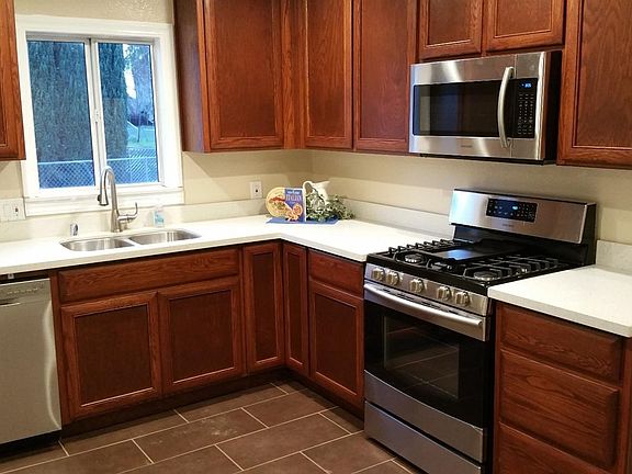 New matching stainless appliances, upgrade tile flooring, wood cabinets and Quartz counter-top