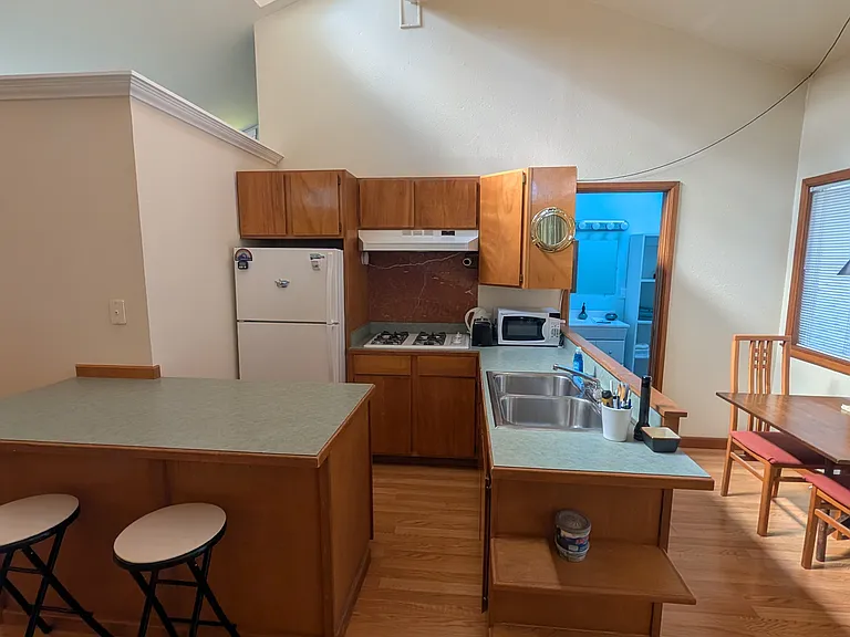 Eat-in bar area off kitchen peninsula, loads of cabinet space and all kitchenware provided