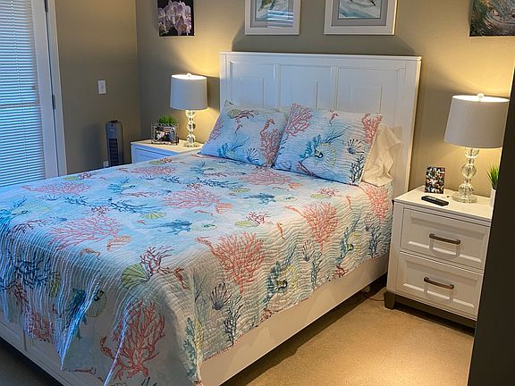 Downstairs queen bedroom (QBR) with lanai access and ultra modern (quiet and powerful remote controlled) ceiling fan.