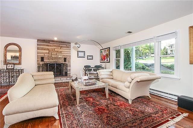 Spacious living room with stone fireplace