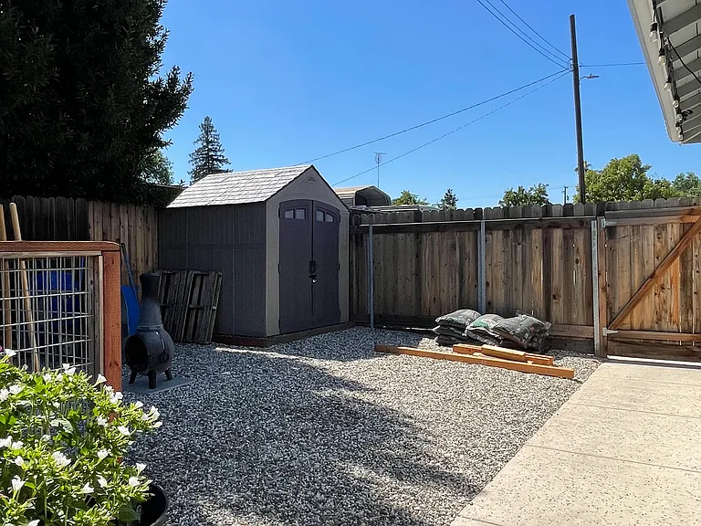 Rocked side yard with 7 ft fence and gate