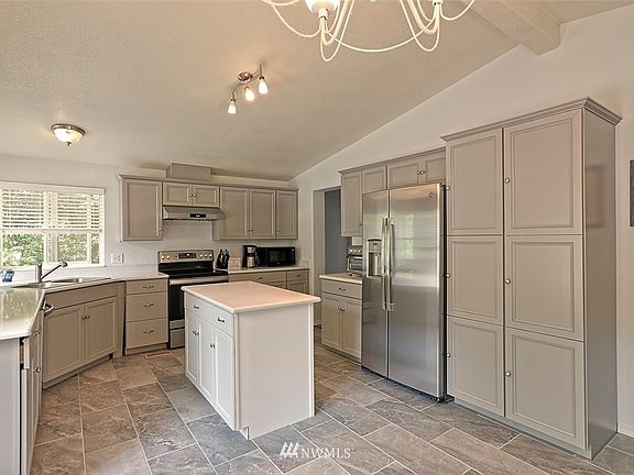 Completely remodeled with new cabinets, beautiful quartz countertops, stainless appliances and tile floor