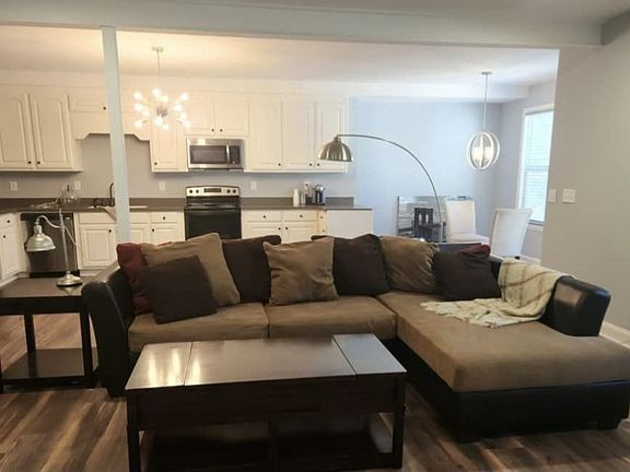 Partailly furnished living room and full size kitchen.