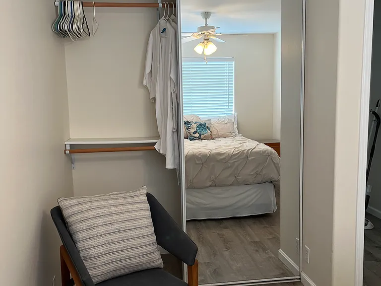 2nd bedroom chair and closet with 2 full length mirrors