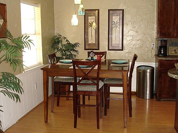 Breakfast Room has Beautiful Light Fixture and Laminate Wood Floor.
