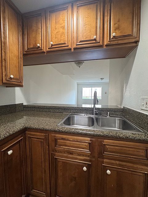 Stainless sink and breakfast bar behind