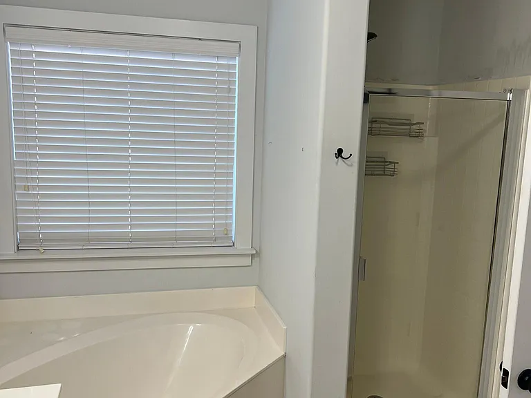 Separate walk in shower in master bath.