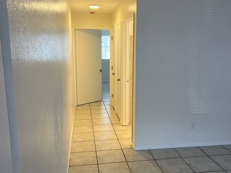 Looking down hallway from living room, towards bedroom.