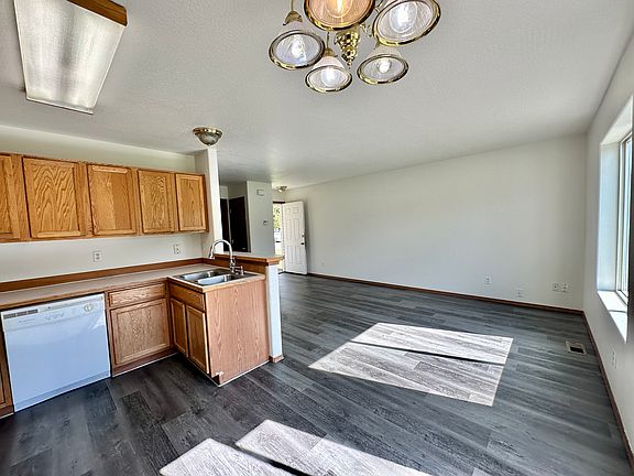Dining area with views into living area. New luxury vinyl flooring and paint.