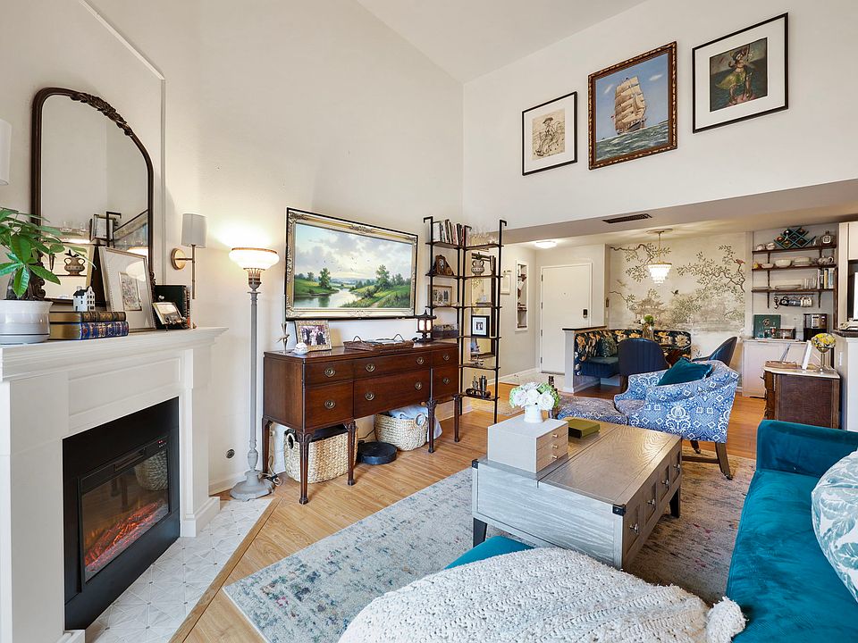 Cozy fireplace ancors the space while the adjacent dining are creates an inviting setting. There is hidden storage behind mirror on fireplace.