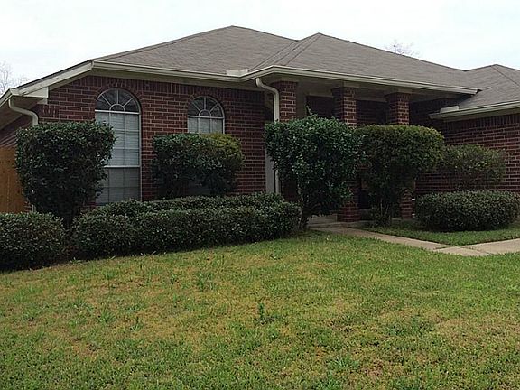 Beautifully landscaped yard and covered front porch