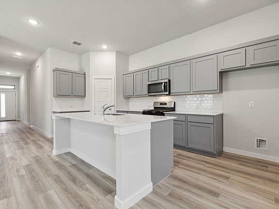 Kitchen in the Quartz home plan by Trophy Signature Homes - REPRESENTATIVE PHOTO
