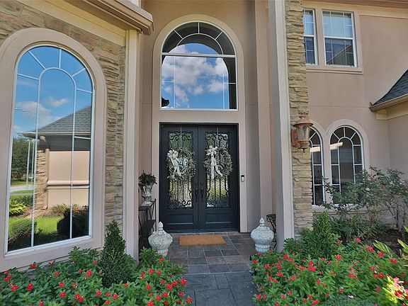 What an inviting entry with double doors and a covered entry.