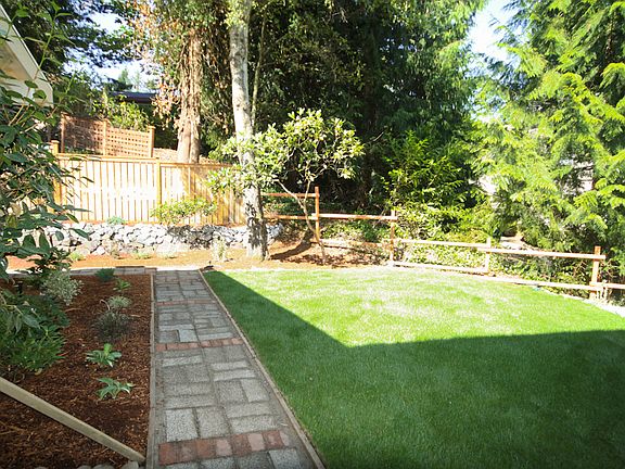 Brick walkway leads to back.