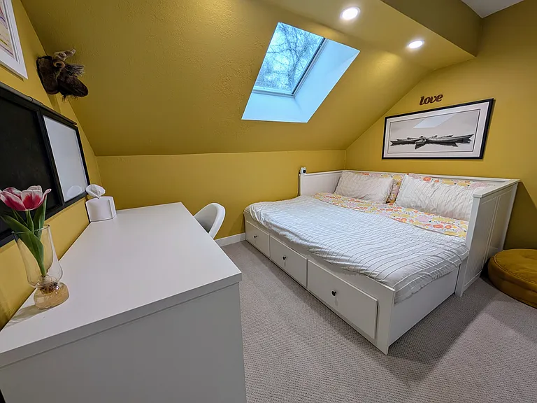 Upstairs Bedroom 1 - King bed that converts into a single daybed. North facing skylight offers natural light and can be opened to let in fresh air.