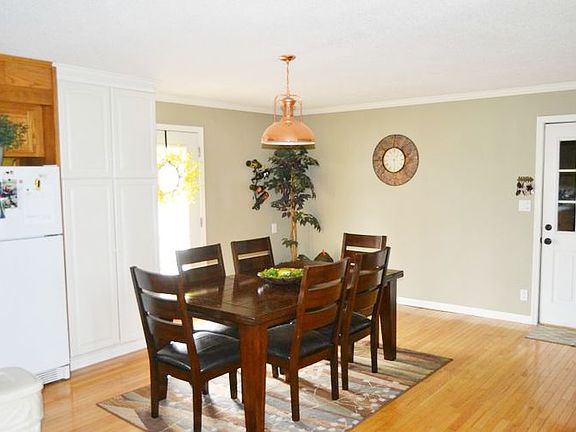 To one side of the entrance is the dining area.  It is just off the kitchen work space.  Easy access from the 2 car garage and their is a back entrance to the rear of the home and patio area. 
