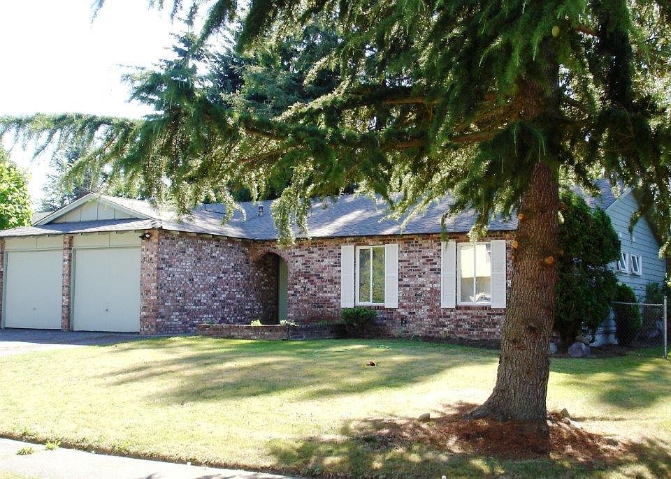Bright sunny front entry with brick and expanded 2 car garag