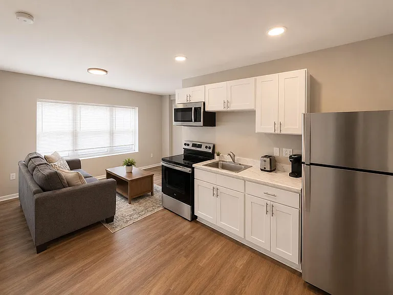Open-concept kitchen with stainless appliances, ample cabinet storage, and a generous window bringing in natural light.