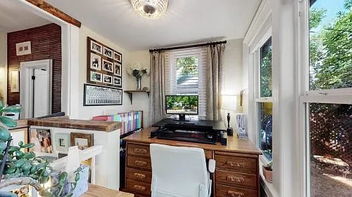 Beautiful bright back porch for an office with a view of the yard.