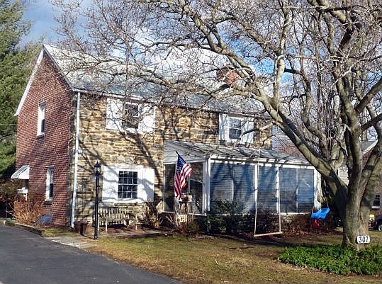 Front showing 3-season porch and beautiful magnolia tree