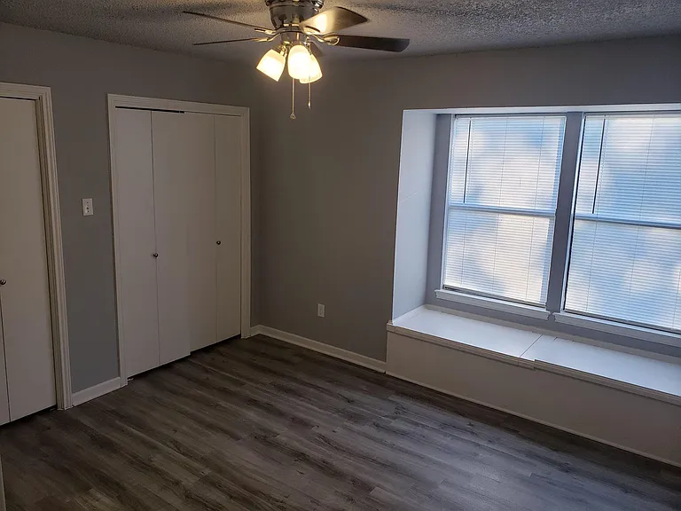Bedroom 1 with window seat storage and 2 closets