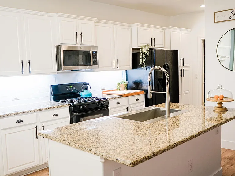 Renovated kitchen with bright, white cabinets, matte black and stainless steel appliances, & XL 33 inches wide farm sink!